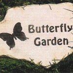 Granite butterfly garden memorial headstone with engraved butterflies and floral design.