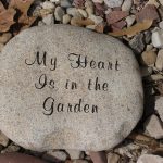 Gray granite upright headstone monument with polished finish in a cemetery memorial setting.