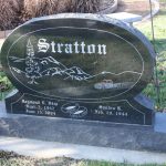 Gray granite double upright headstone monument with polished face for a shared cemetery memorial.