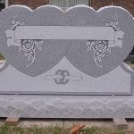 Gray granite double upright headstone monument with polished face for a shared family memorial.